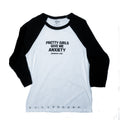 A 3/4 sleeve raglan baseball t-shirt with a white body and black sleeves, featuring the text 'PRETTY GIRLS GIVE ME ANXIETY' printed in black on the chest.